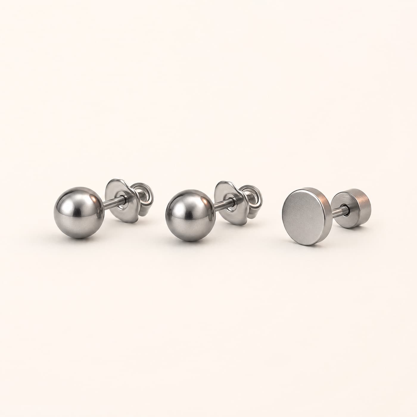 Titanium Starter Set — Two Studs and a Flat-Back, shown as a single piece